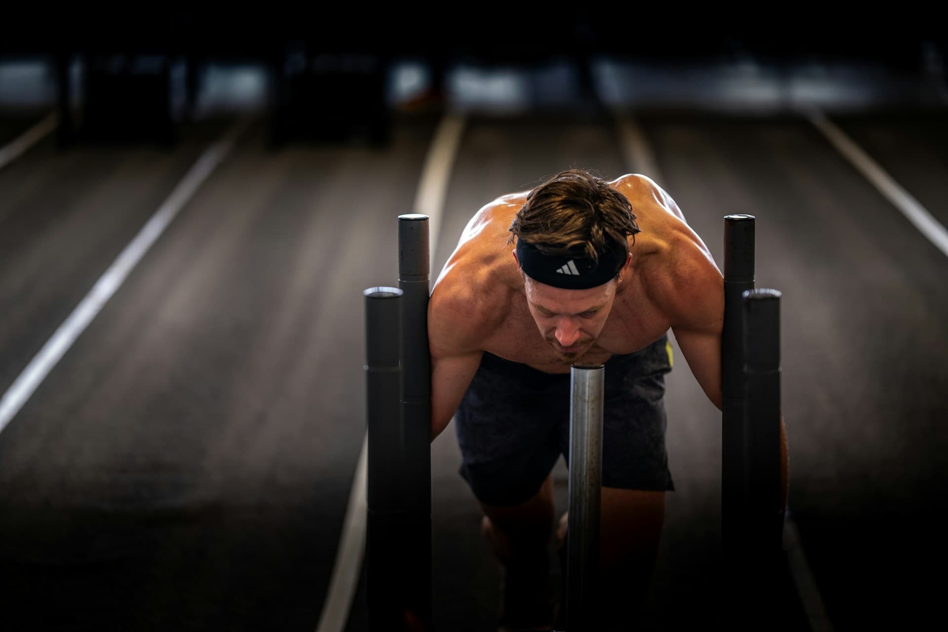 Athlete pushing through reps at a functional-fitness station
