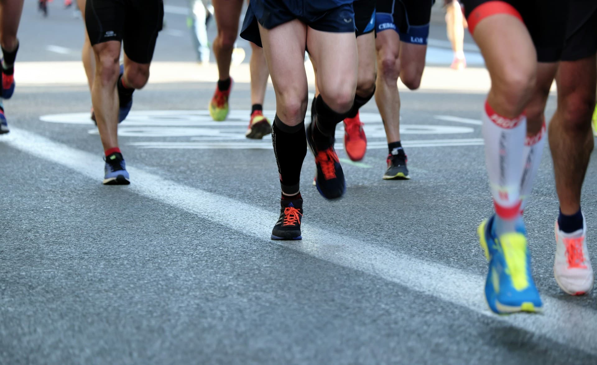 A field of runners on a city street during a road marathon
