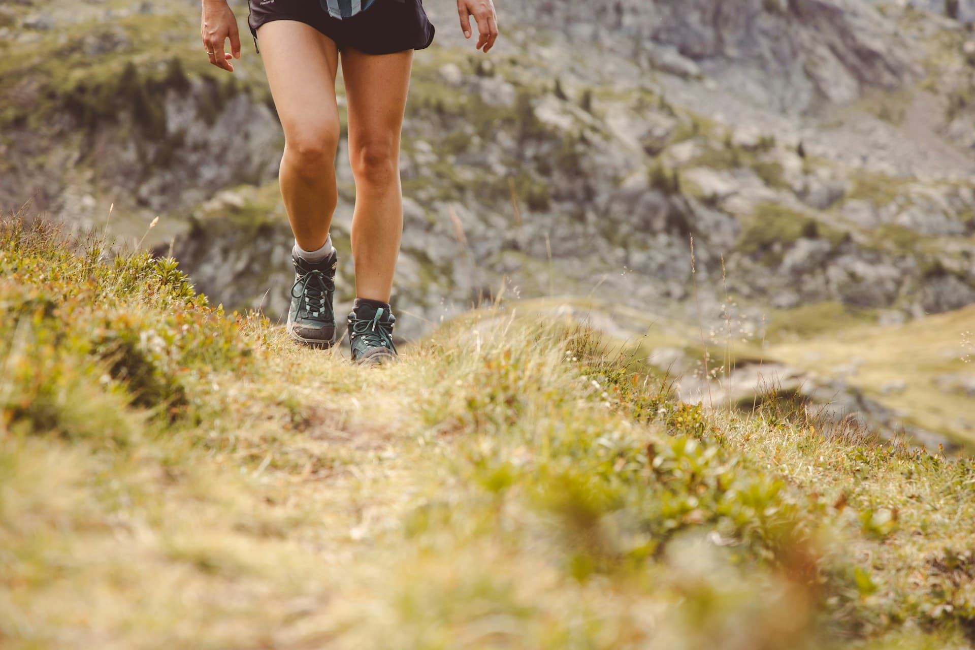 Trail runners climbing a technical mountain section on an ultra course