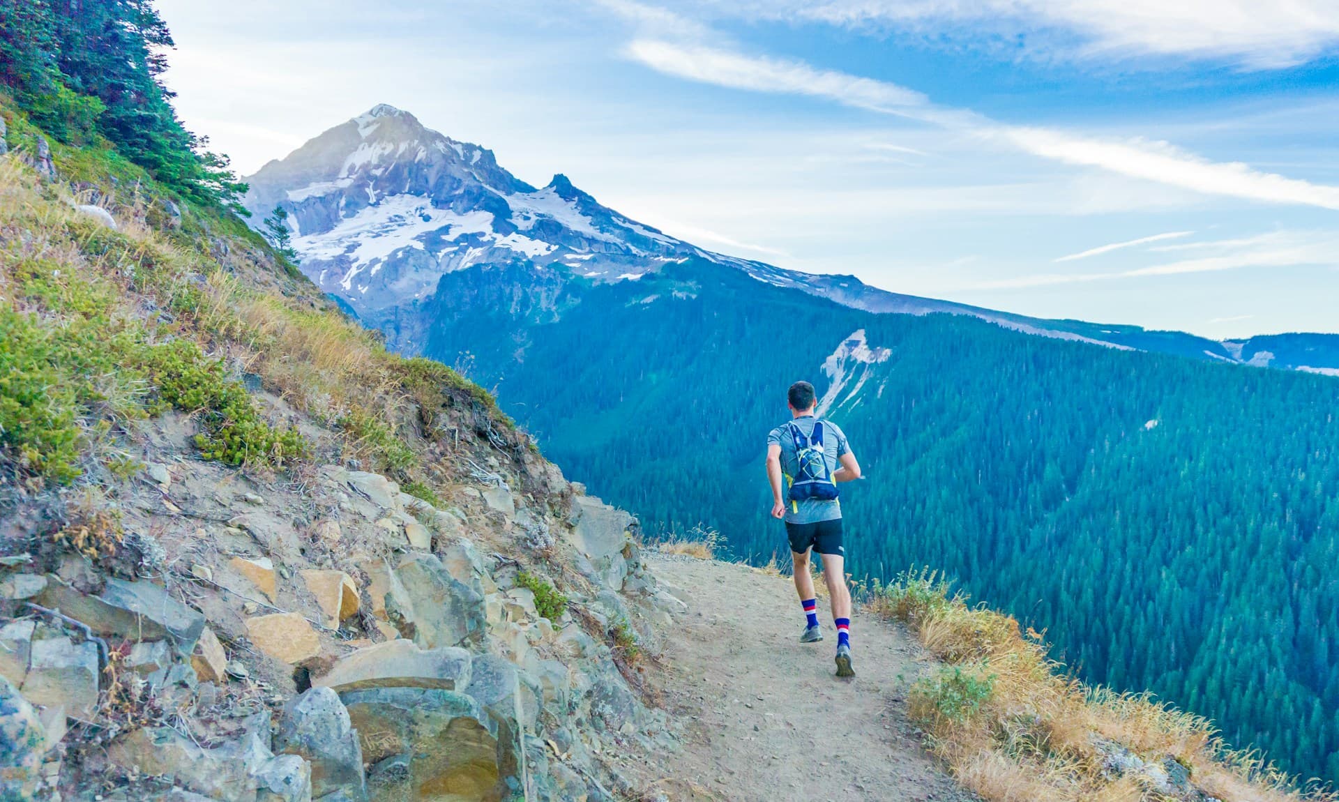 A trail runner on a mountain ridge during an off-road ultra