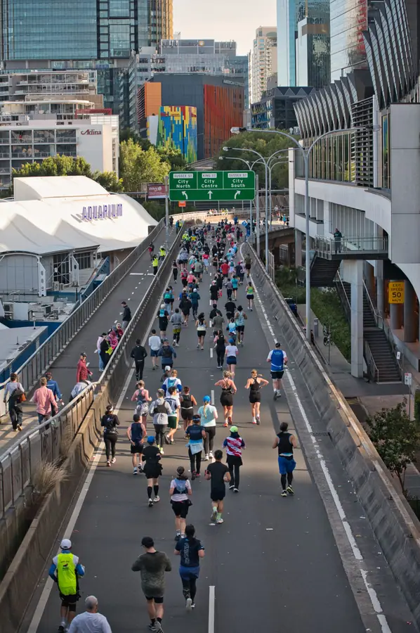 Athlete crossing the finish line at Harbor Dawn Half marathon